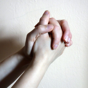 fingers interlaced, palms together